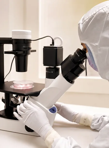 CelestiaLab scientist reviewing laboratory samples under a microscope